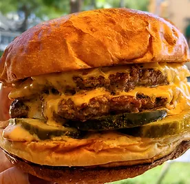 Palmino double cheeseburger with pickles and secret sauce